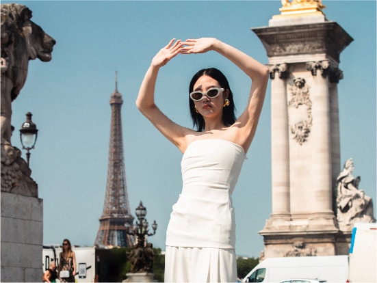 Female model wearing white Proenza Schouler set and white sunglasses in Paris